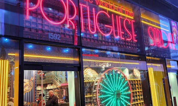 The Fantastic World of the Portuguese Sardine — neon storefront with ferris wheel